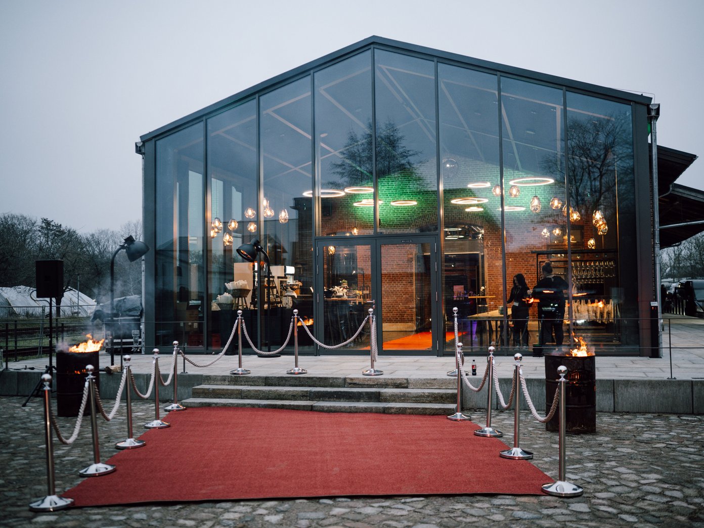 Roter Teppich und Kordeln vor einem Glaswintergarten